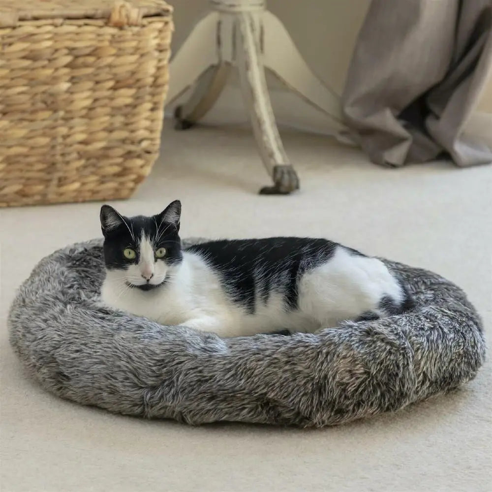 Cozy cat bed with a black and white cat lounging comfortably in a soft, plush design.