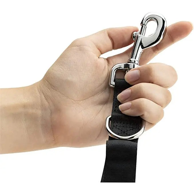 Hand holding a durable dog leash clip, showcasing its sturdy design and functionality.