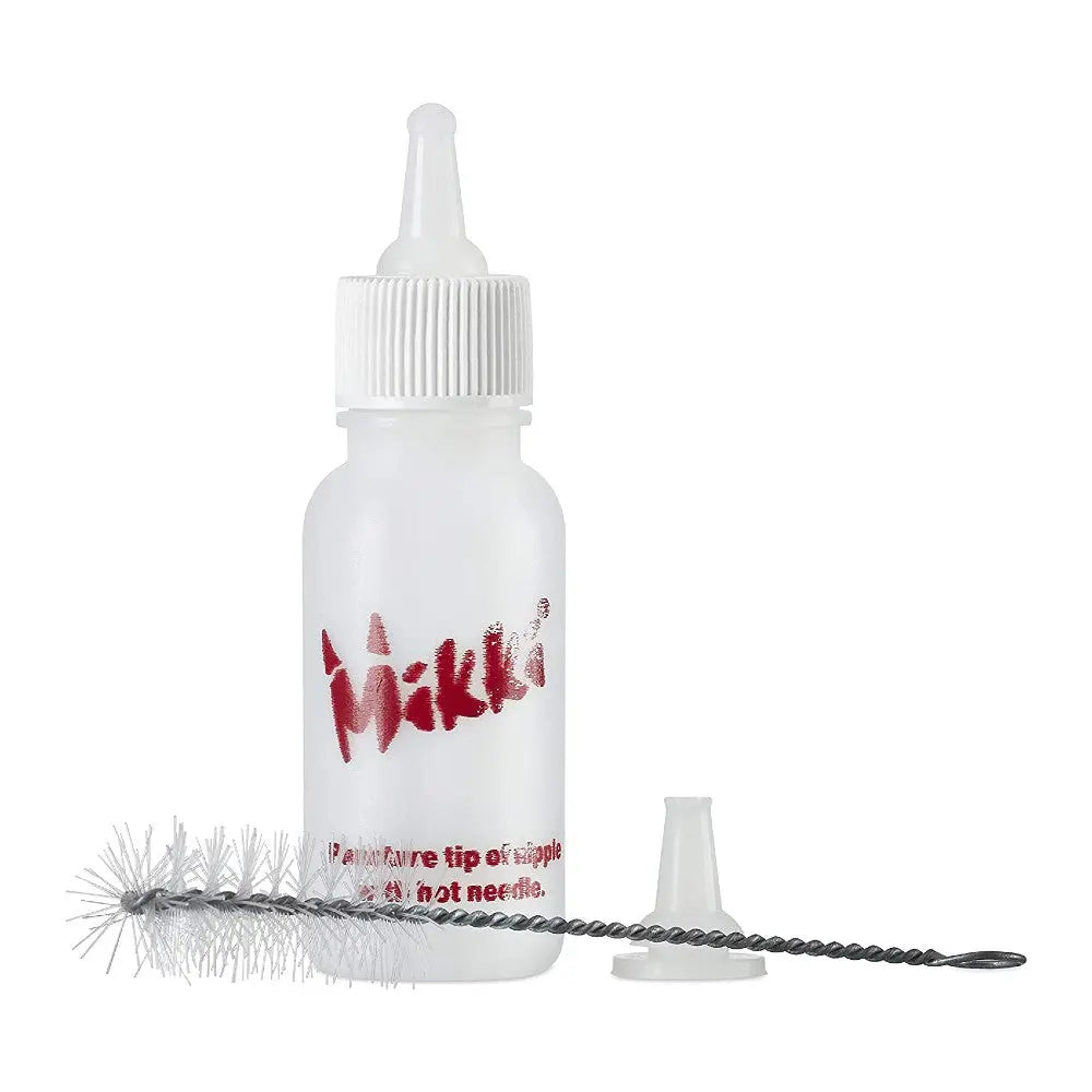 Mikki bottle with removable tip and cleaning brush for easy application and maintenance.
