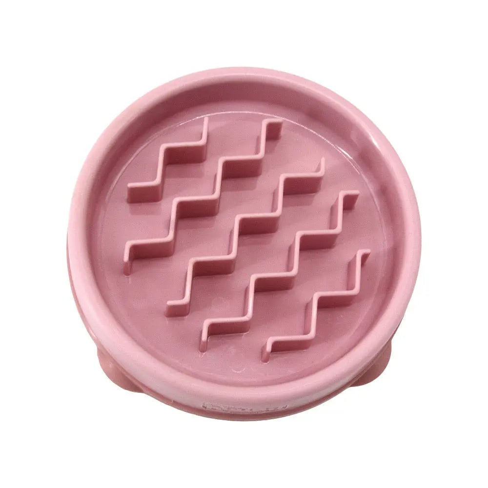 Pink slow feeder bowl with zigzag patterns for promoting healthy eating in pets.