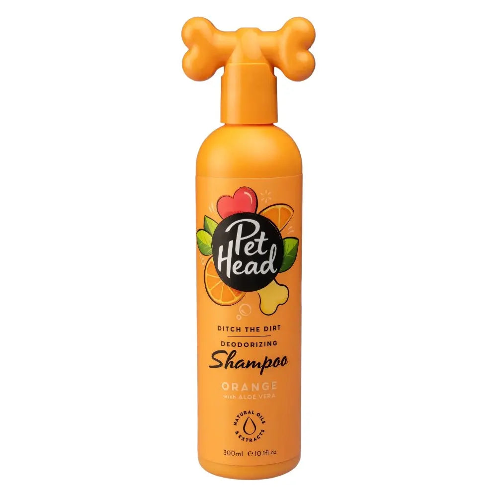 Pet Head orange deodorizing shampoo for dogs in a playful bone-shaped bottle.