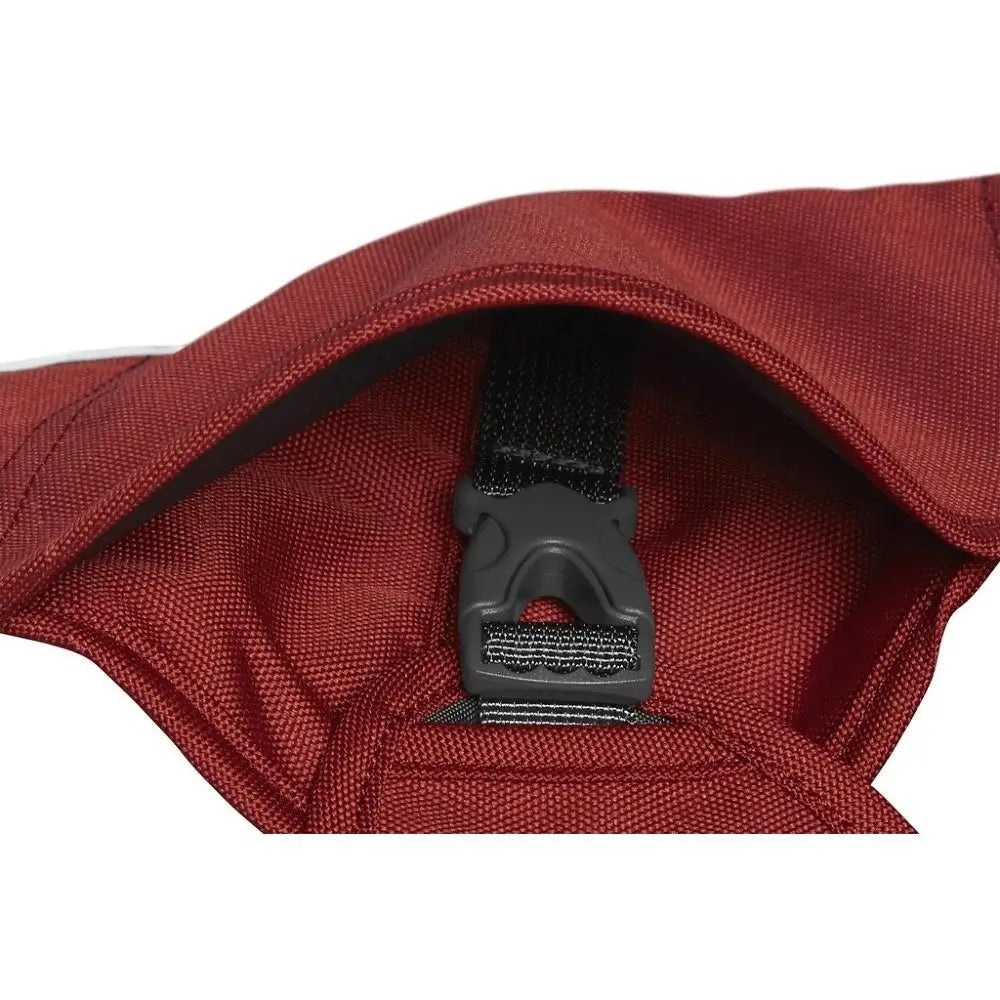 Close-up of a maroon bag's interior featuring a secure buckle and adjustable strap for convenience.