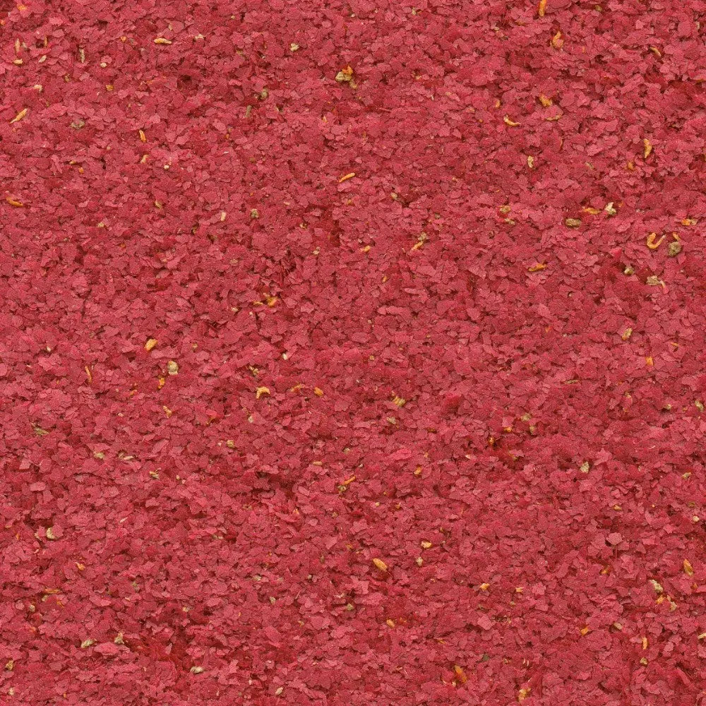 Bright red spice blend texture, perfect for enhancing dishes with vibrant color and flavor.