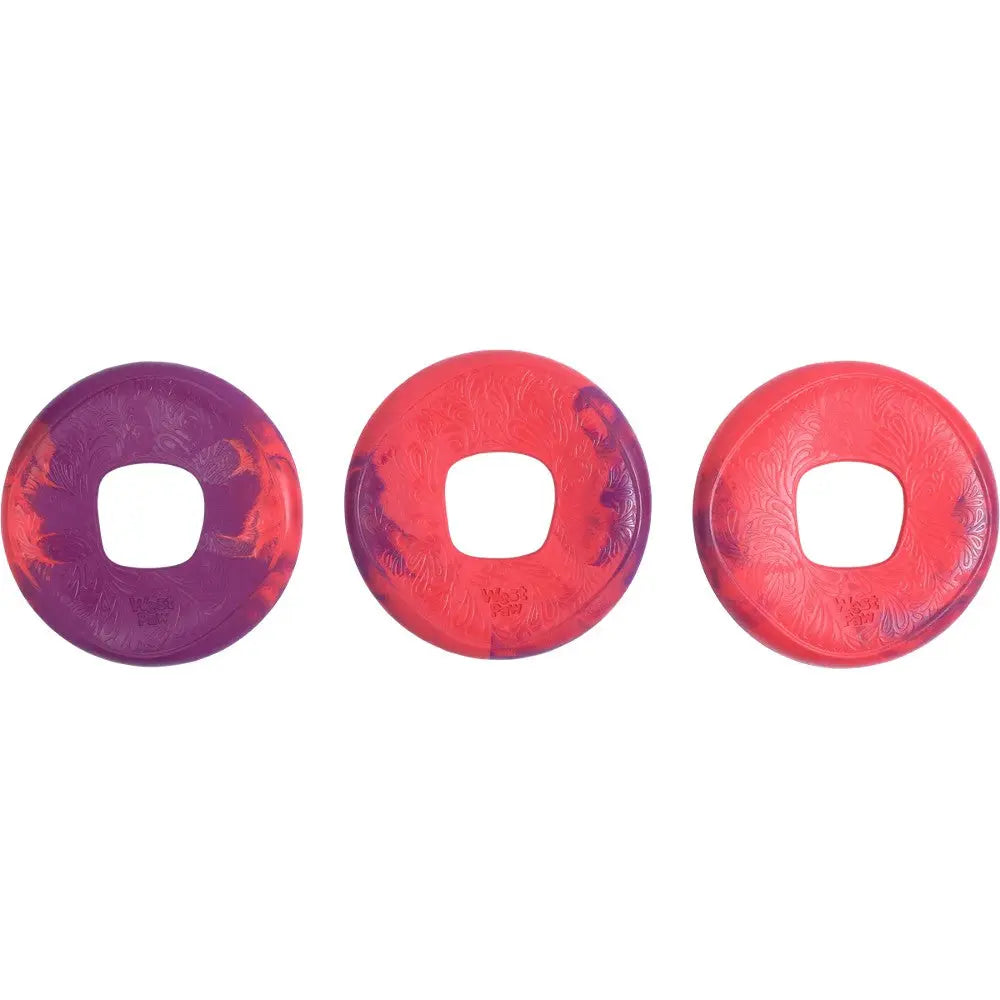 Colorful dog frisbees in purple and red, designed for outdoor play and fetch activities.