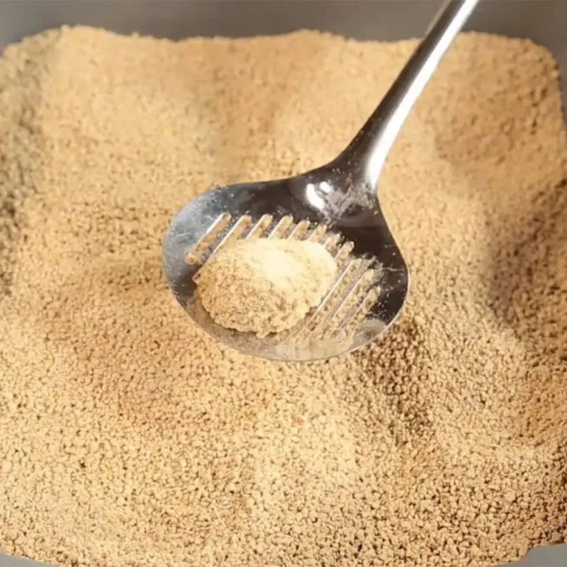 Scoop of fine powder in a bowl, showcasing texture and color for ingredient use.